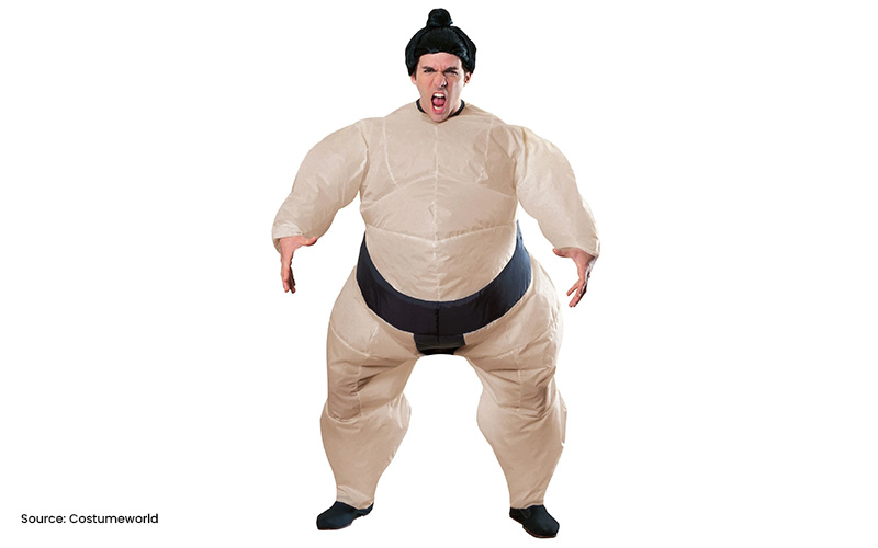 Adult in an inflatable sumo wrestler costume yelling.
